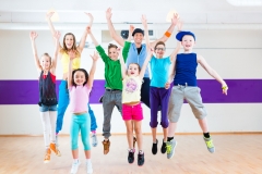Dance teacher giving kids Zumba fitness class