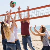 Friends playing volleyball at beach
